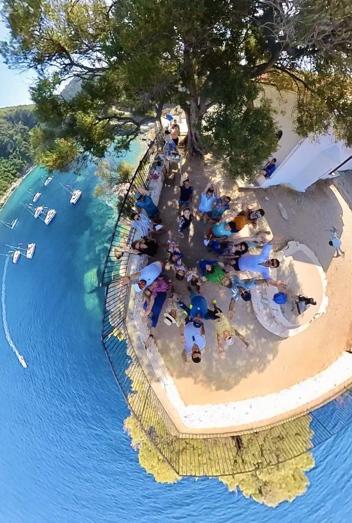 A 360 degree view of people sitting on a beach