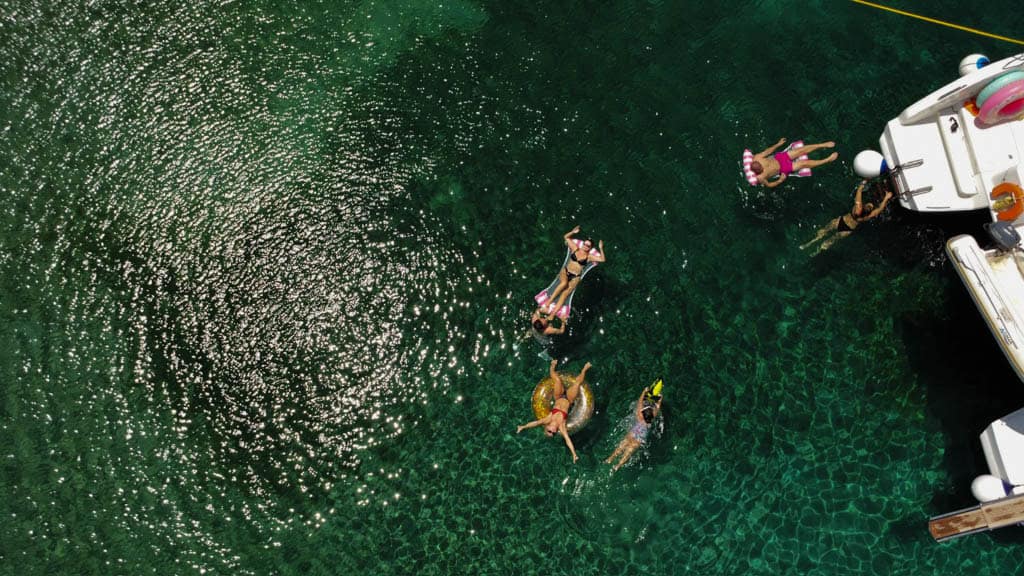 People enjoying sun on turquoise waters